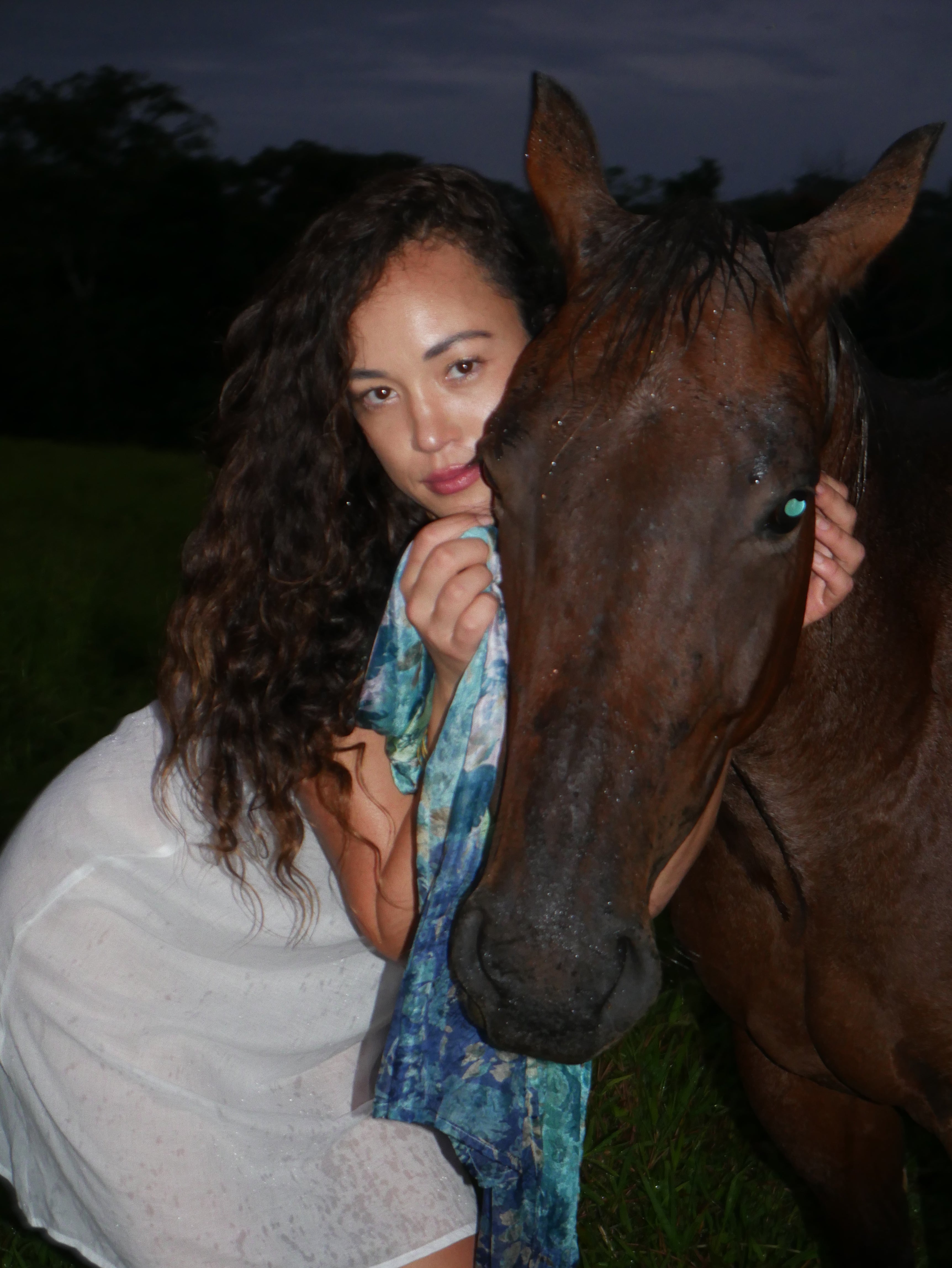Model in a navy floral silk scarf, photographed at Olson Keolanui Farms in Hilo.